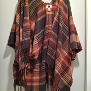 Red/ orange combo poncho with fringe.  One size fits most! Oversized.